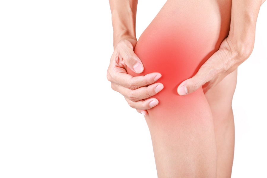 a person grabbing their hip that is being affected by inflammation