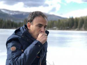 a man suffering from respiratory illness coughing