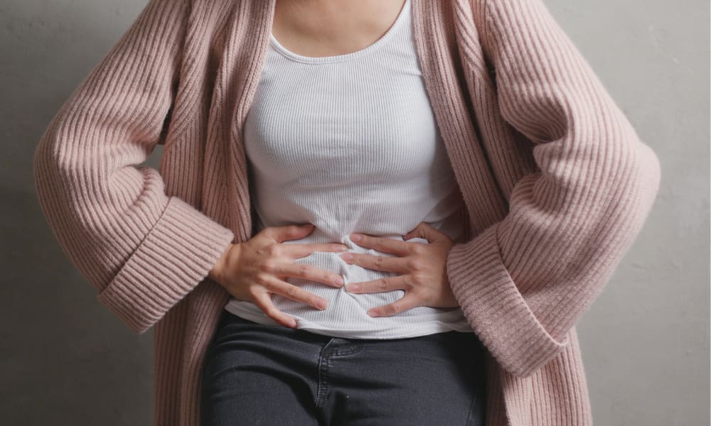 woman with her hands on her stomach